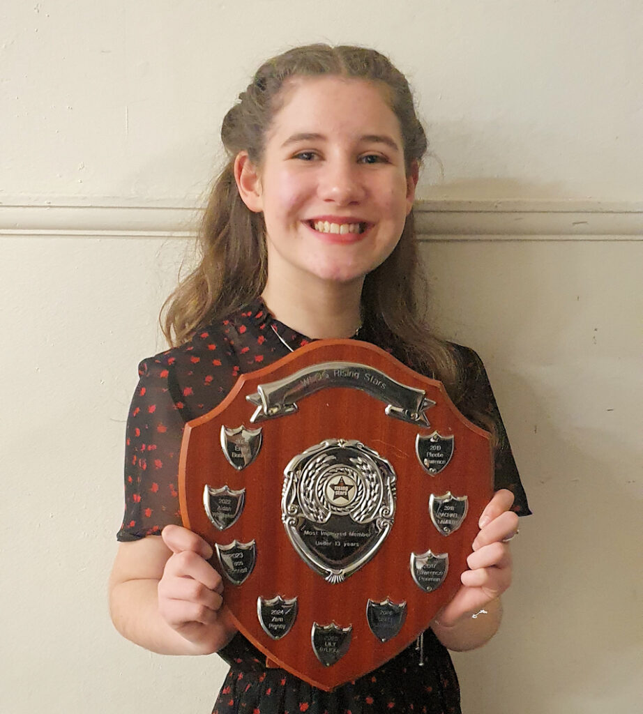 Grace with the award shield for Most Improved member - under 13 years
